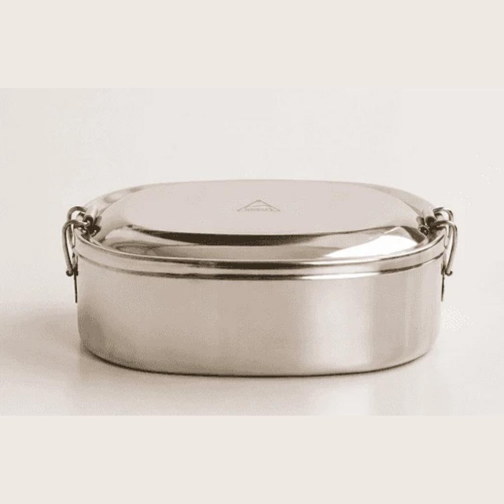 Front view of the Shasta oval stainless steel bento box with its lid secured by metal locking clips on a neutral background. Lorikeet Living.